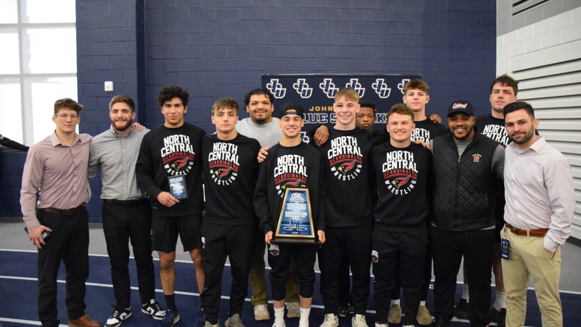 NCC Men's Wrestling poses with regionals second place trophy