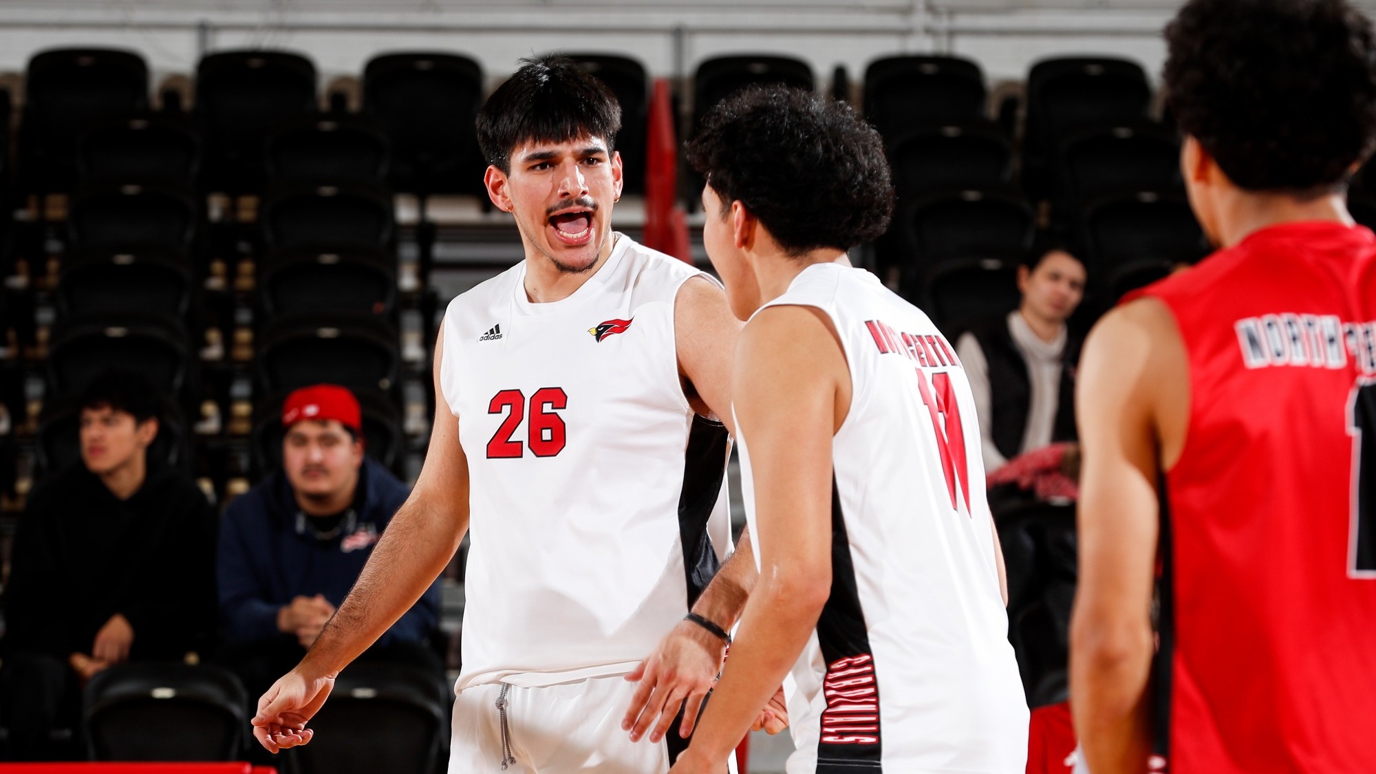 Elijah Landeros celebrates with a teammate after scoring a point in a match