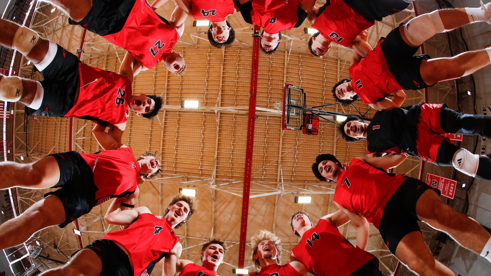 NCC Men's volleyball jumps in a circle in excitement prior to a match.