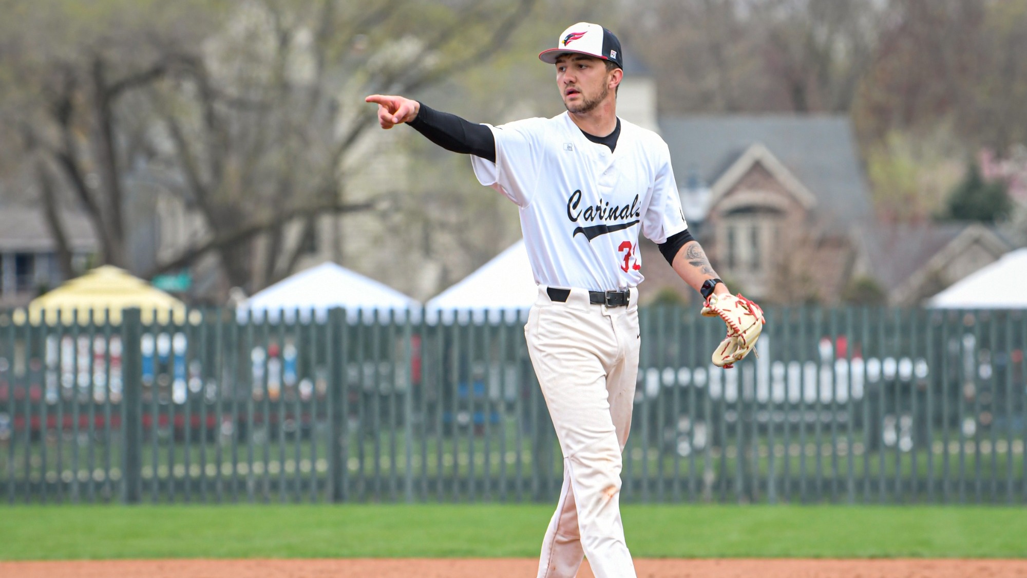 Payton Diaz playing first base and pointing to his teammates