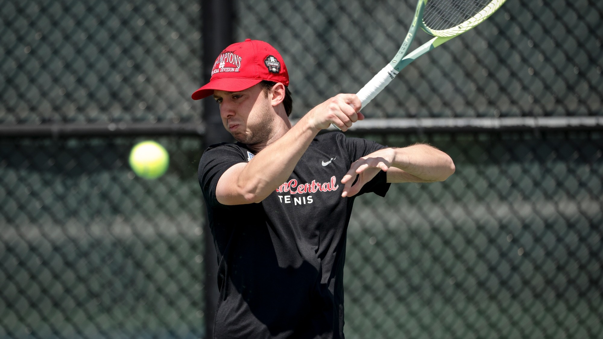 Matt Crossland watches closely as he follows through with a forehand shot during a tennis match