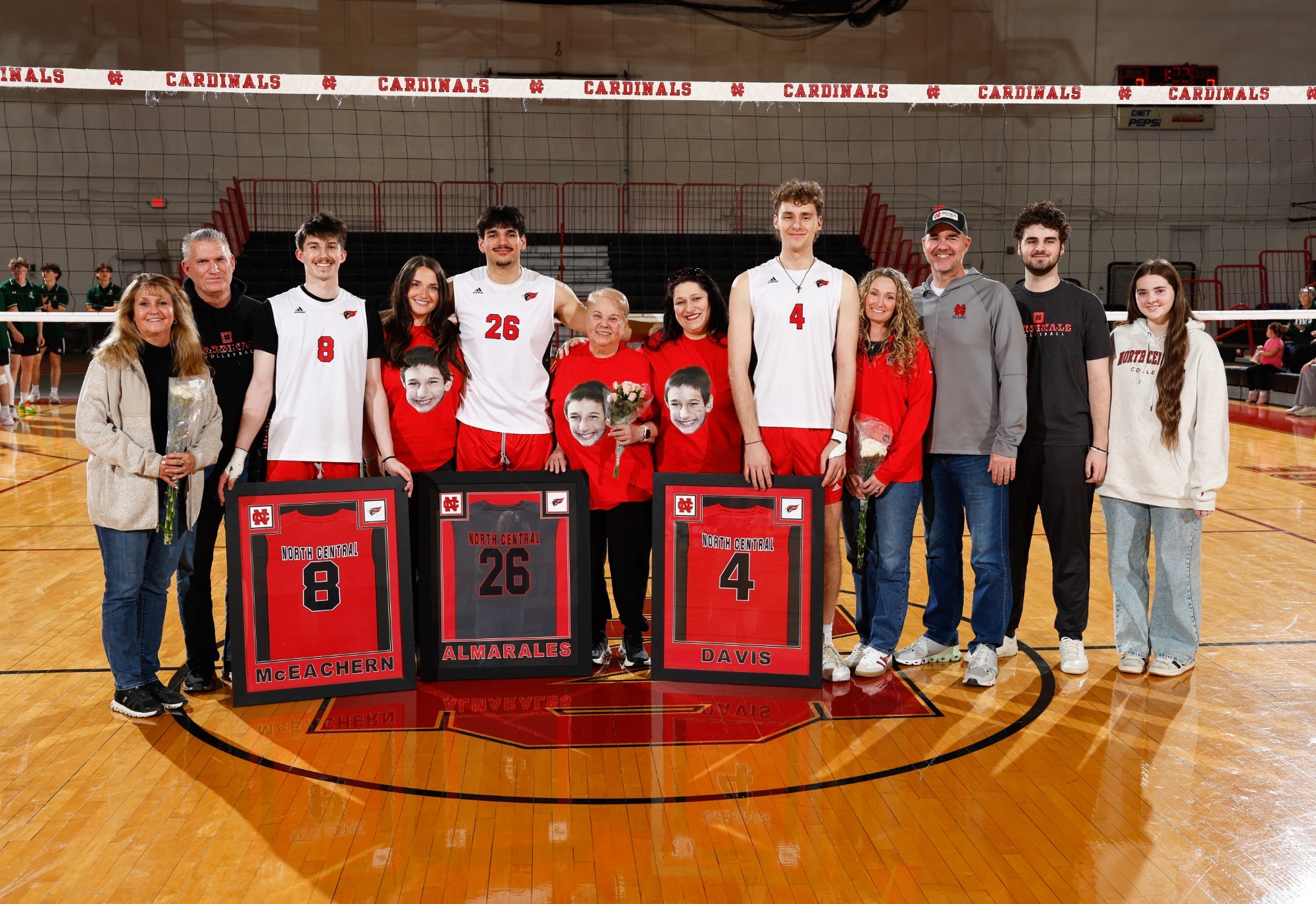 Players Pose with Their Families holding plaques to commemorate Senior Day