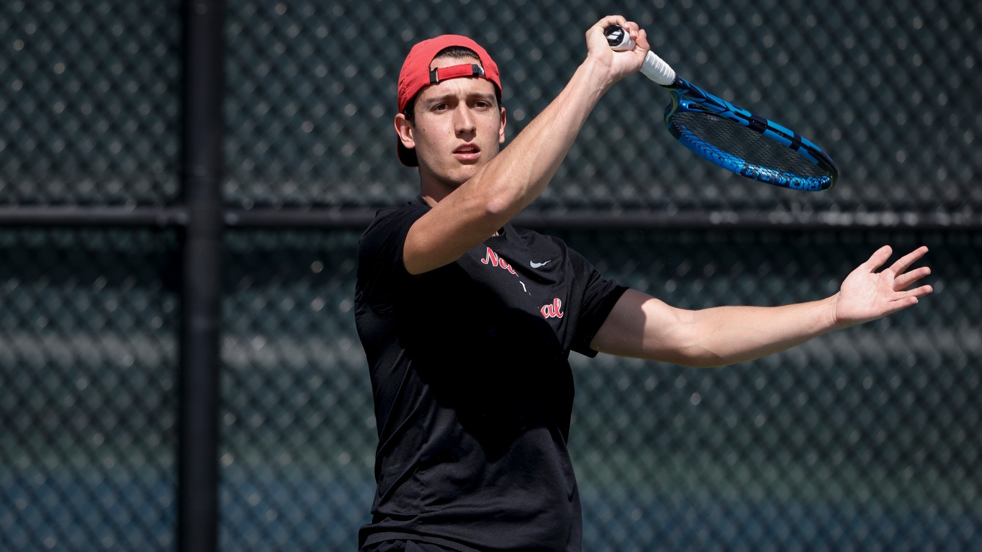 Rafael holds his follow through after taking a swing with his forehand