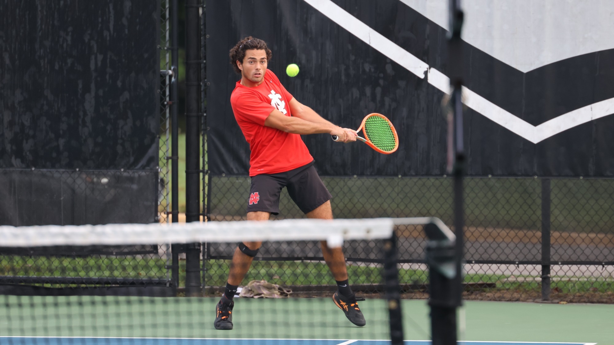 Andres Valverde Gonzalez returns a shot using a backhand during ITA Regionals