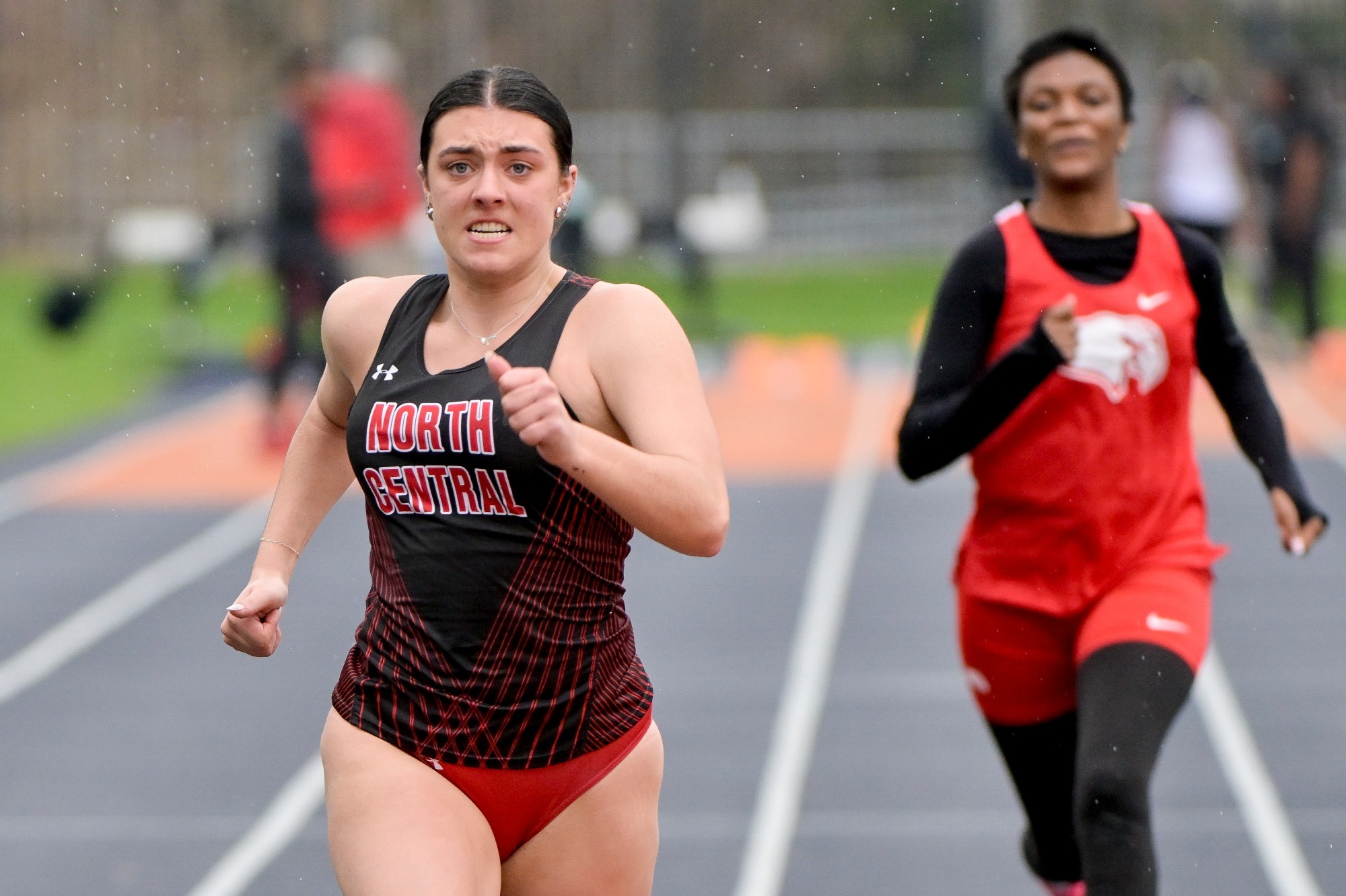 Women's track races at Wheaton College in the rain