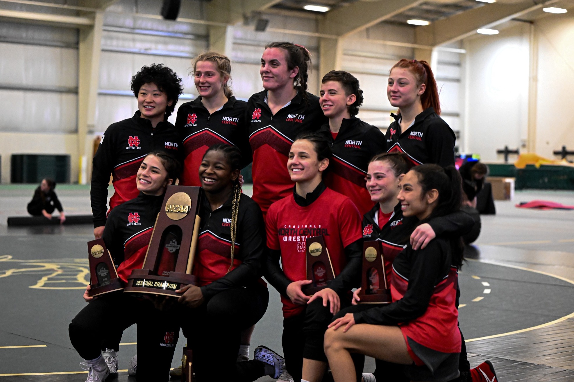Women's Wrestling with NCAA Regional Champ trophy