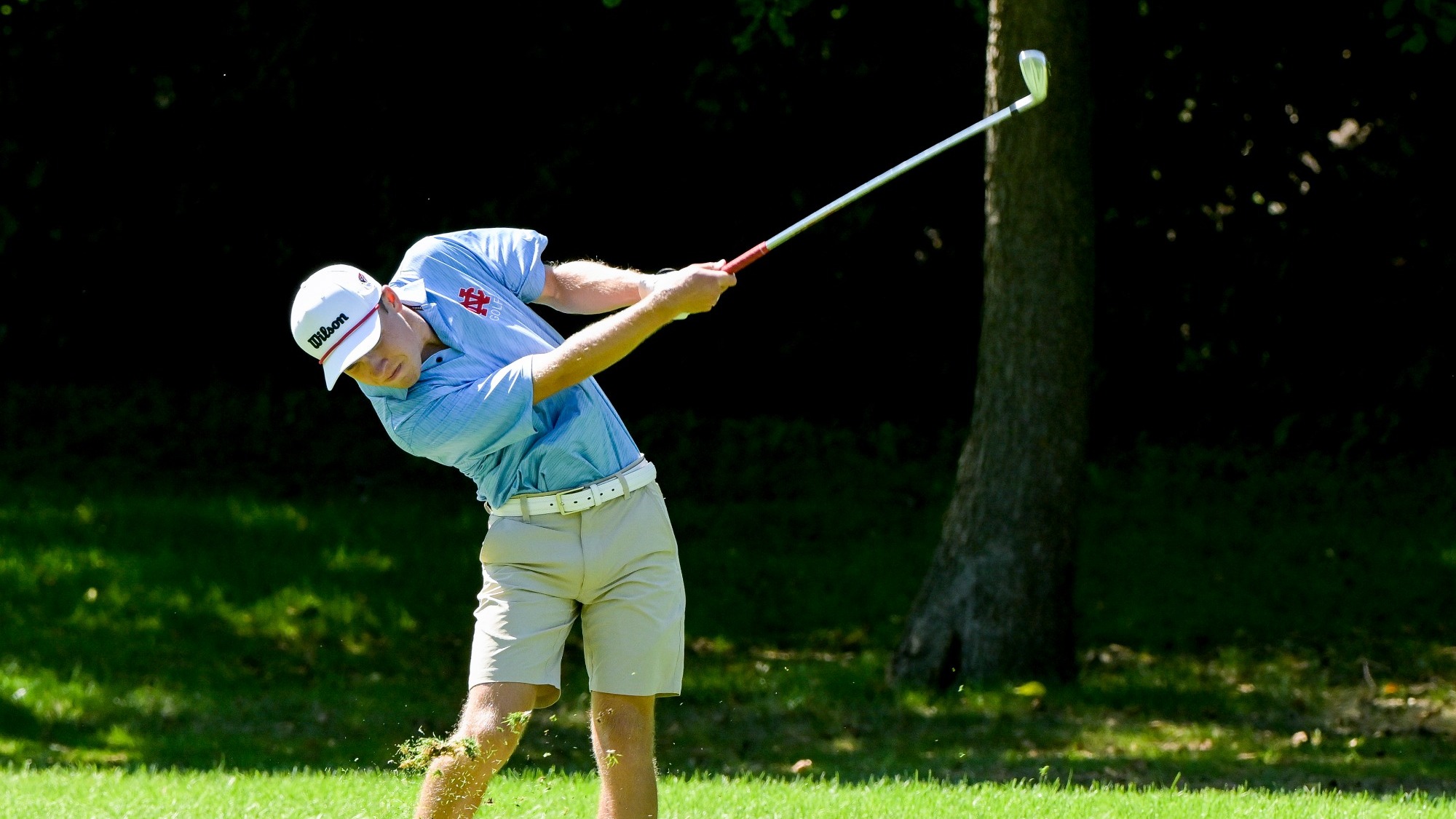 Nicholas Zaimins swinging an iron at the Aurora Golf Meet