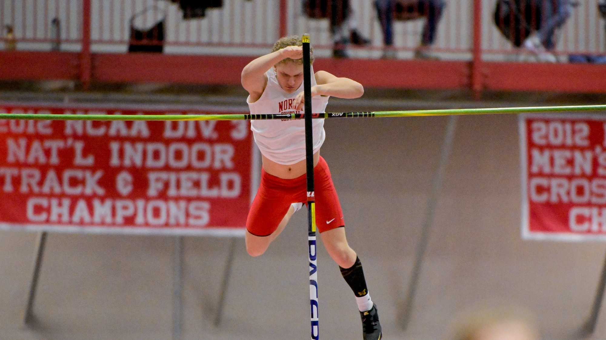 Bobby Guetthoff making it over the bar for the North Central College men's track and field in the pole vault event. 