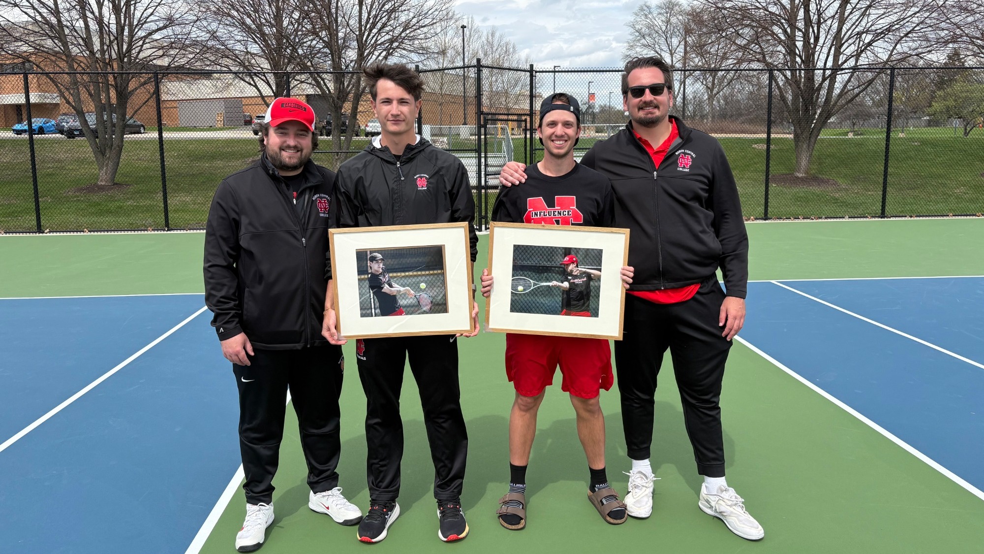 Seniors Matt Crossland and Ignacio Hernandez Ruiz pose with their framed action photos alongside head coach Joey Leto and Graduate Assistant Danilo Kovaciviec.