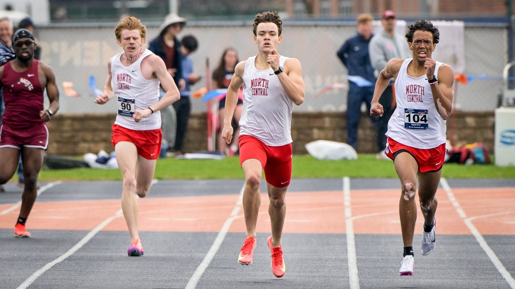 Men's track and field middle-distance runners coming down homestretch