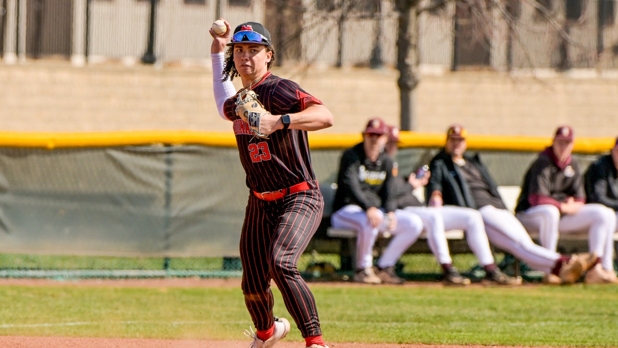 Caleb Smith throwing the baseball from third base to first base for an out