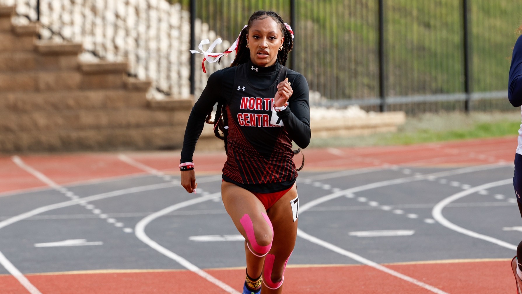 Elianna Keyes racing down the 200m homestretch at CCIW Championships