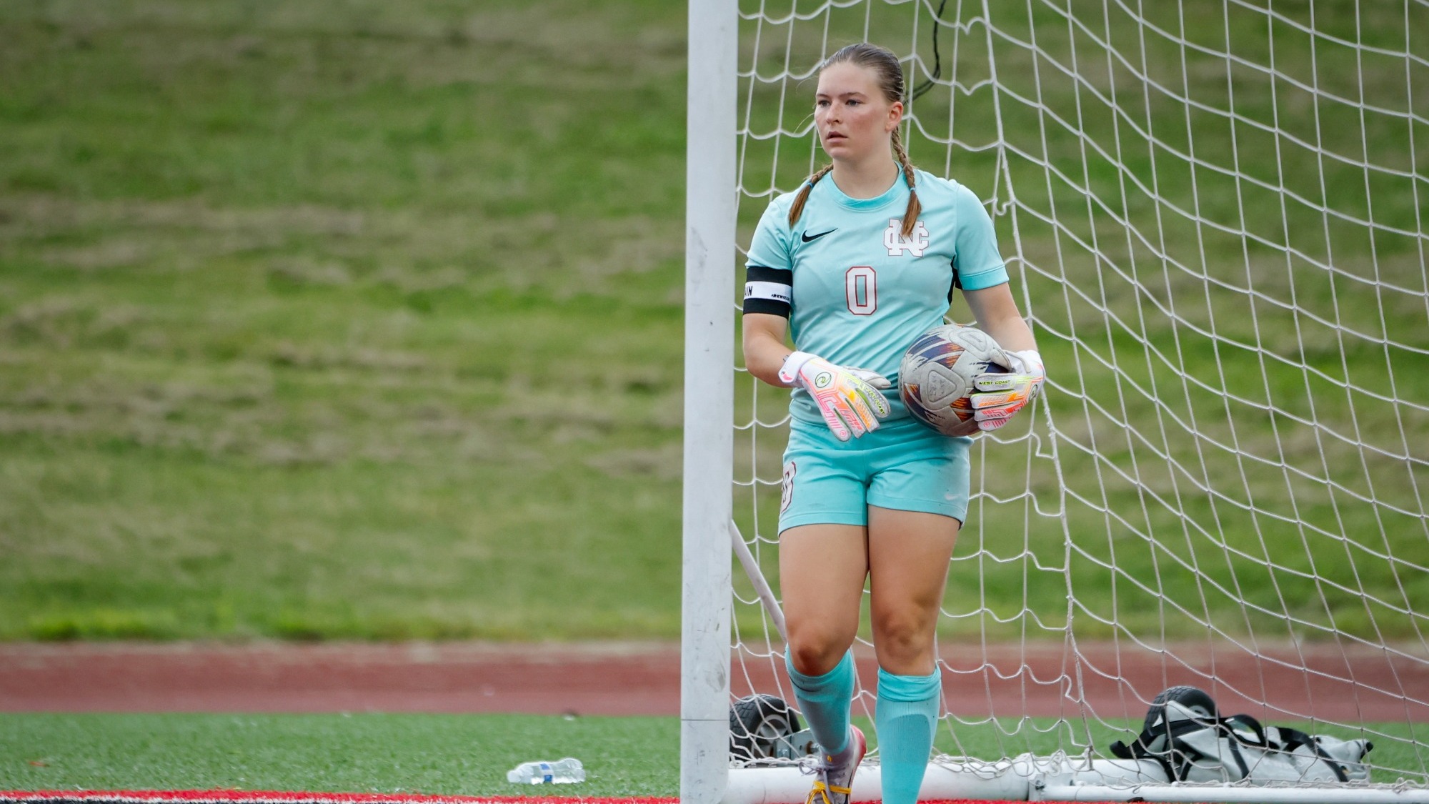 Lily Mattison stands in goal with the ball vs Benedictine