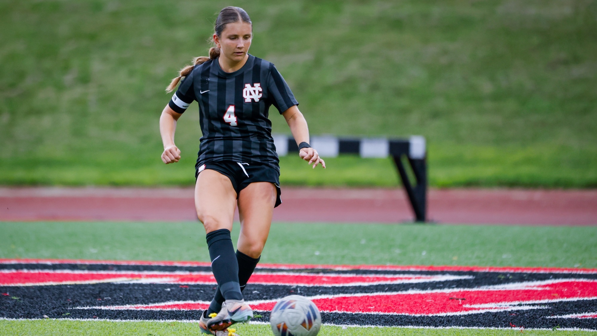 Lauren Richards passes the soccer ball vs Benedictine