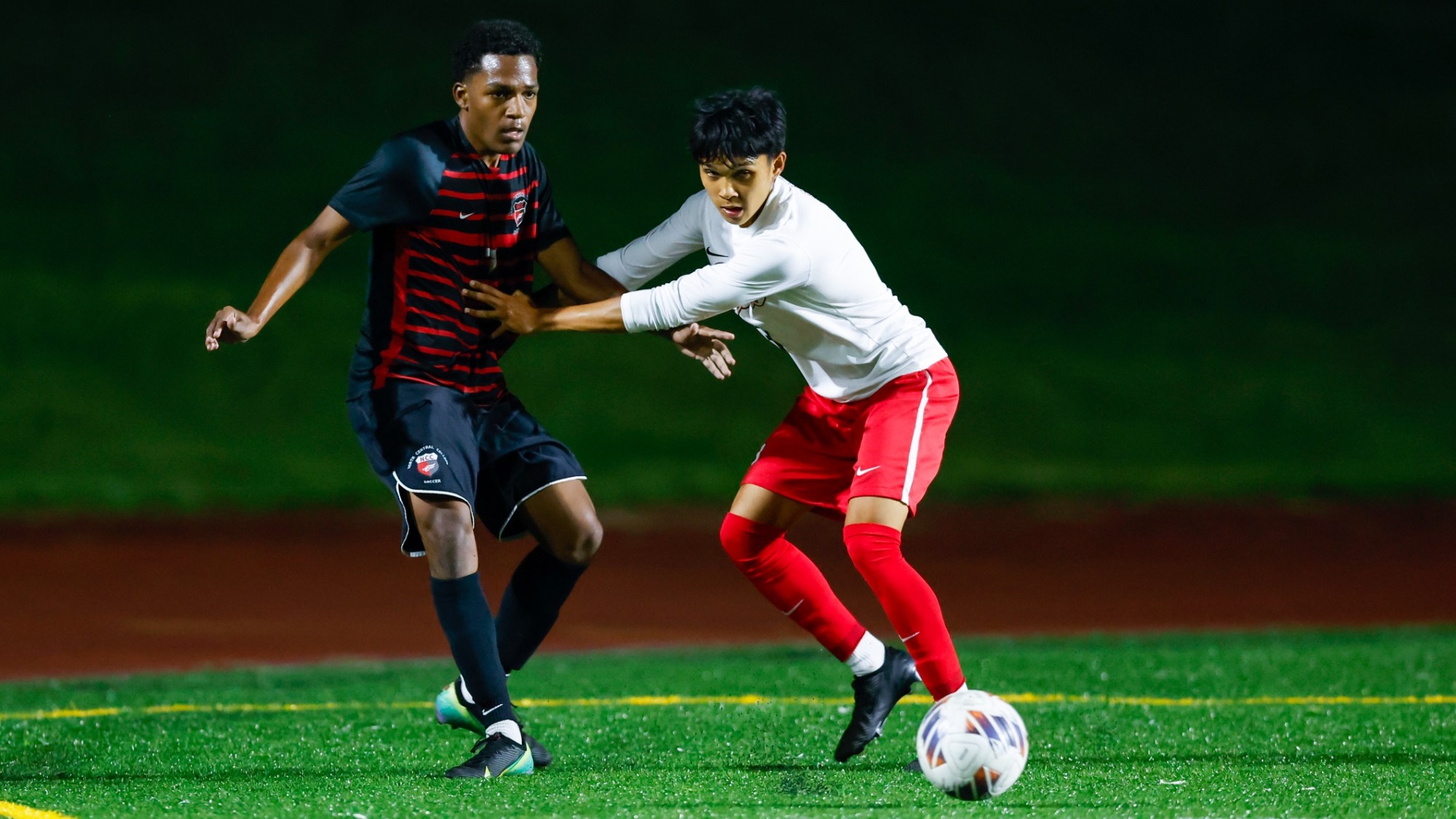 Eltayeb Mahmoud from the North Central College men's soccer team trying to win the ball from his Benedictine University defender on Sept. 3, 2026.