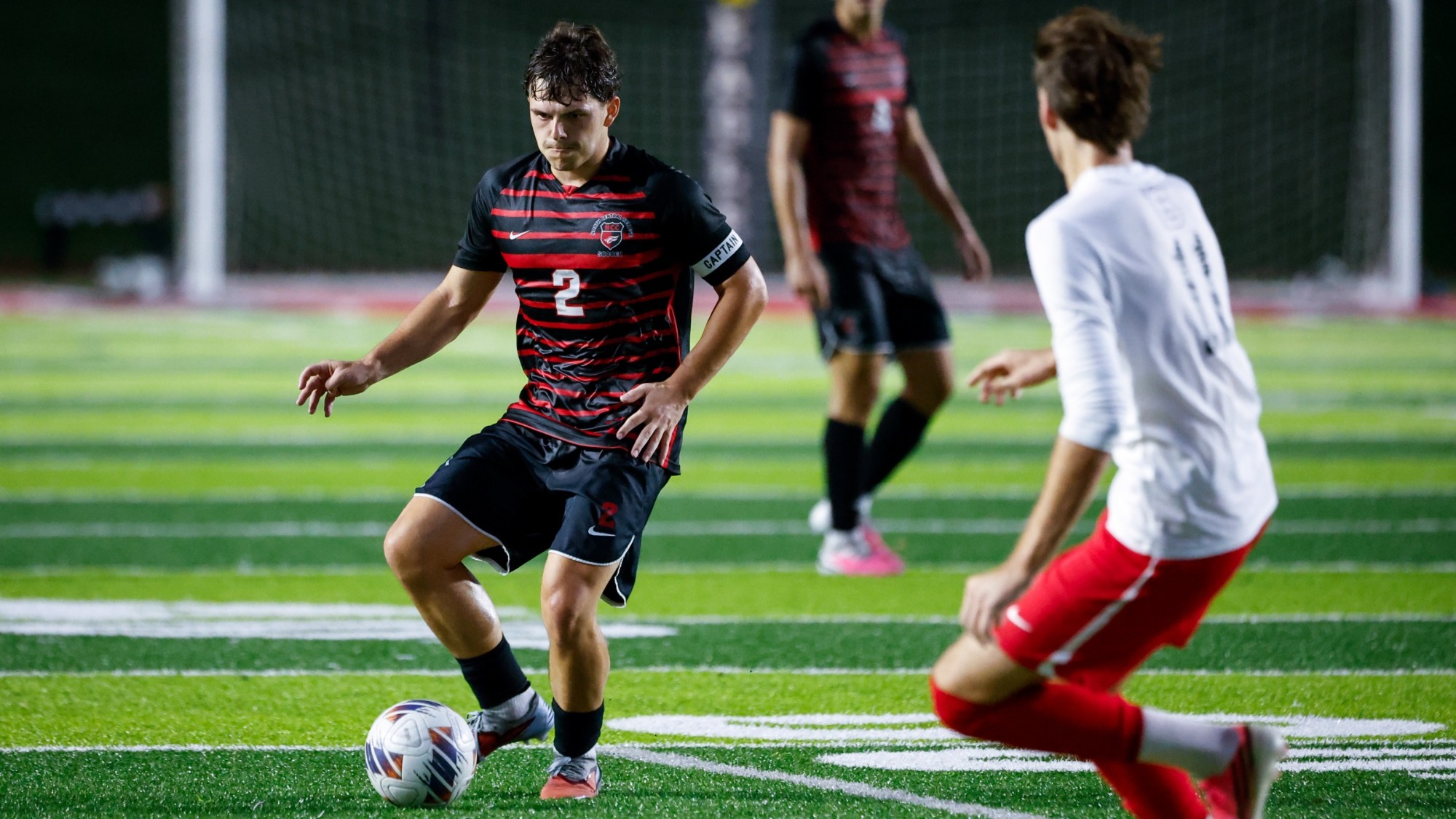 Will Mayer from North Central College men's soccer team passing the ball past Benedictine University on Sept. 3, 2026.