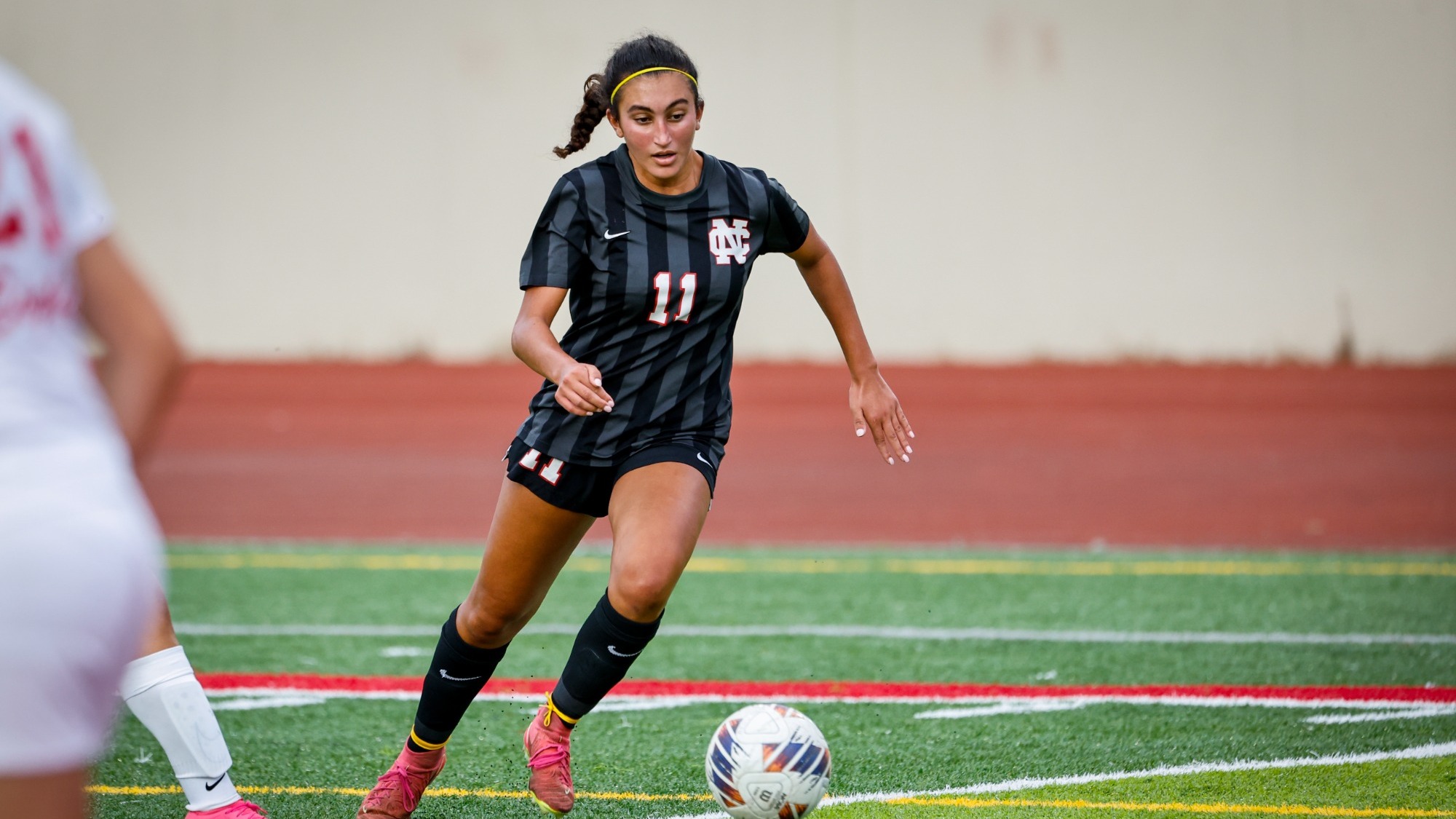 Claire Georgees dribbles ball upfield against Benedictine
