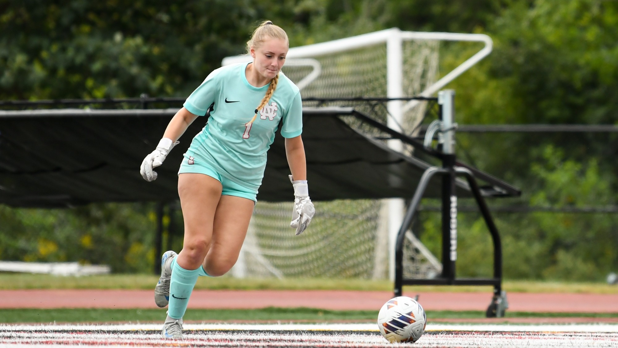 Emma Megerle services ball against Centre College