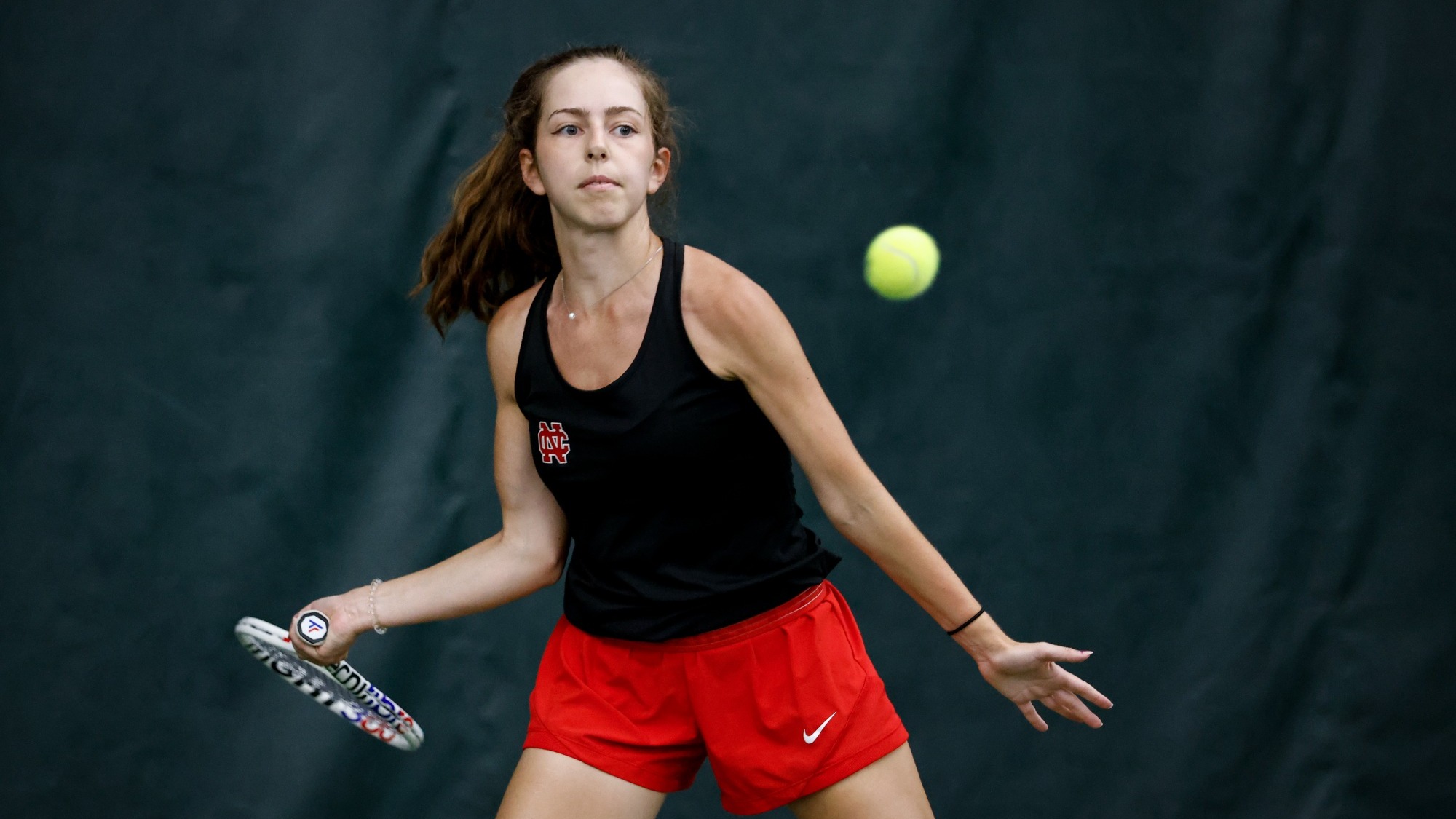 Kate Herlihy begins to take a swing at a tennis ball during a practice.
