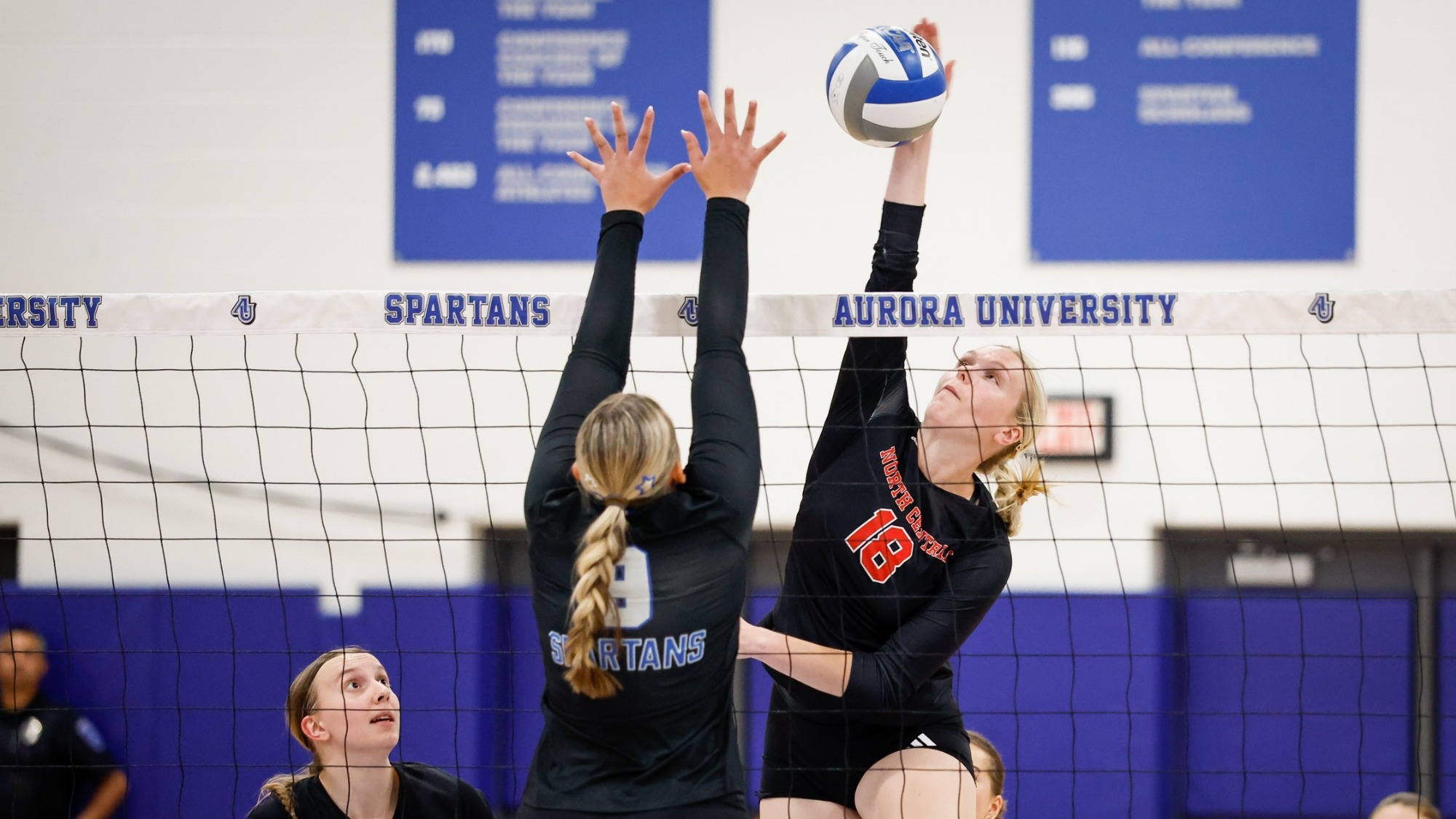 Lauren Benson spiking the ball vs Aurora