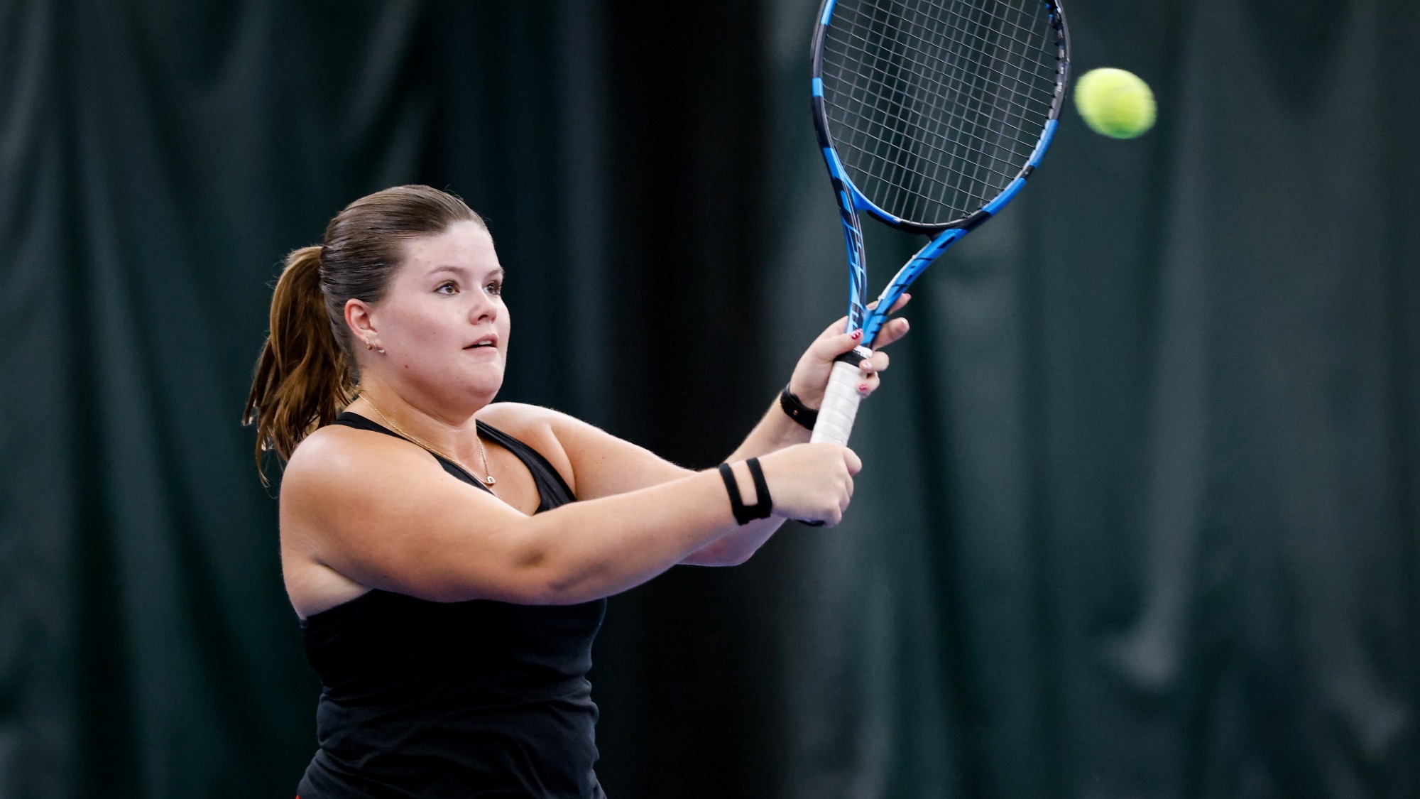 Meghan McSweeney volleys a shot during a tennis practice.