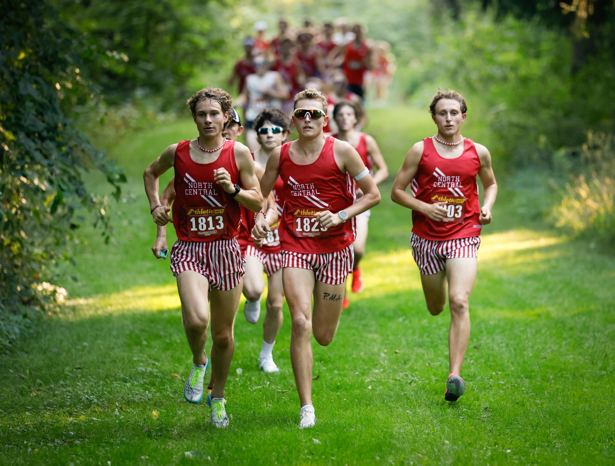 BJ Sorg, Ricky Klein, Daniel Kasperan break from the woods at NCCXC Invite