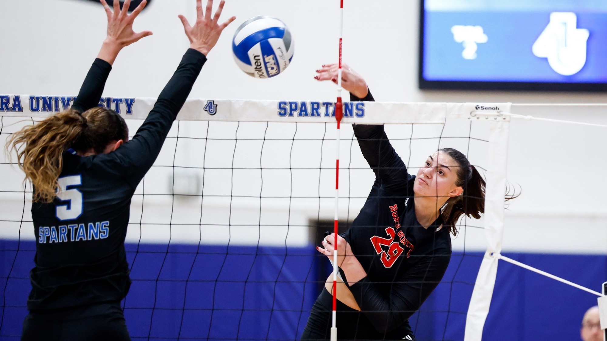 Abby Buban spikes the ball vs Aurora