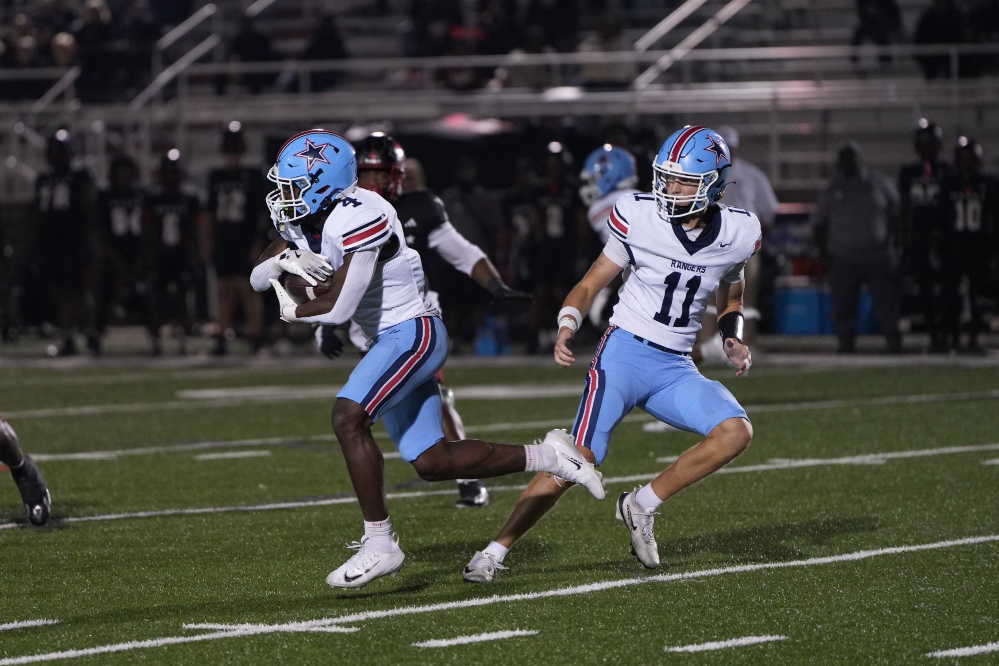 Gillon hands off to DJ Woods during the Rangers 38-28 win over East