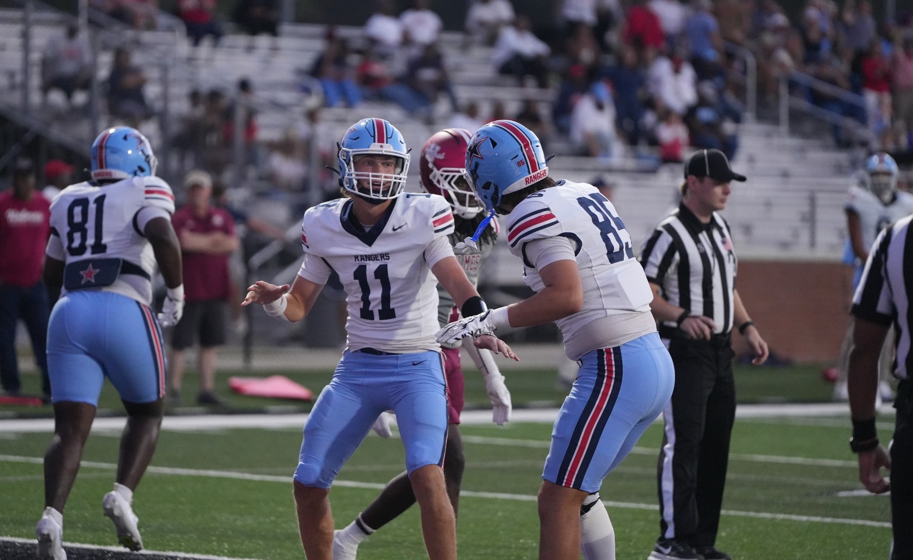 Noah Gillon celebrates with a teammate after scoring his first of two rushing touchdowns