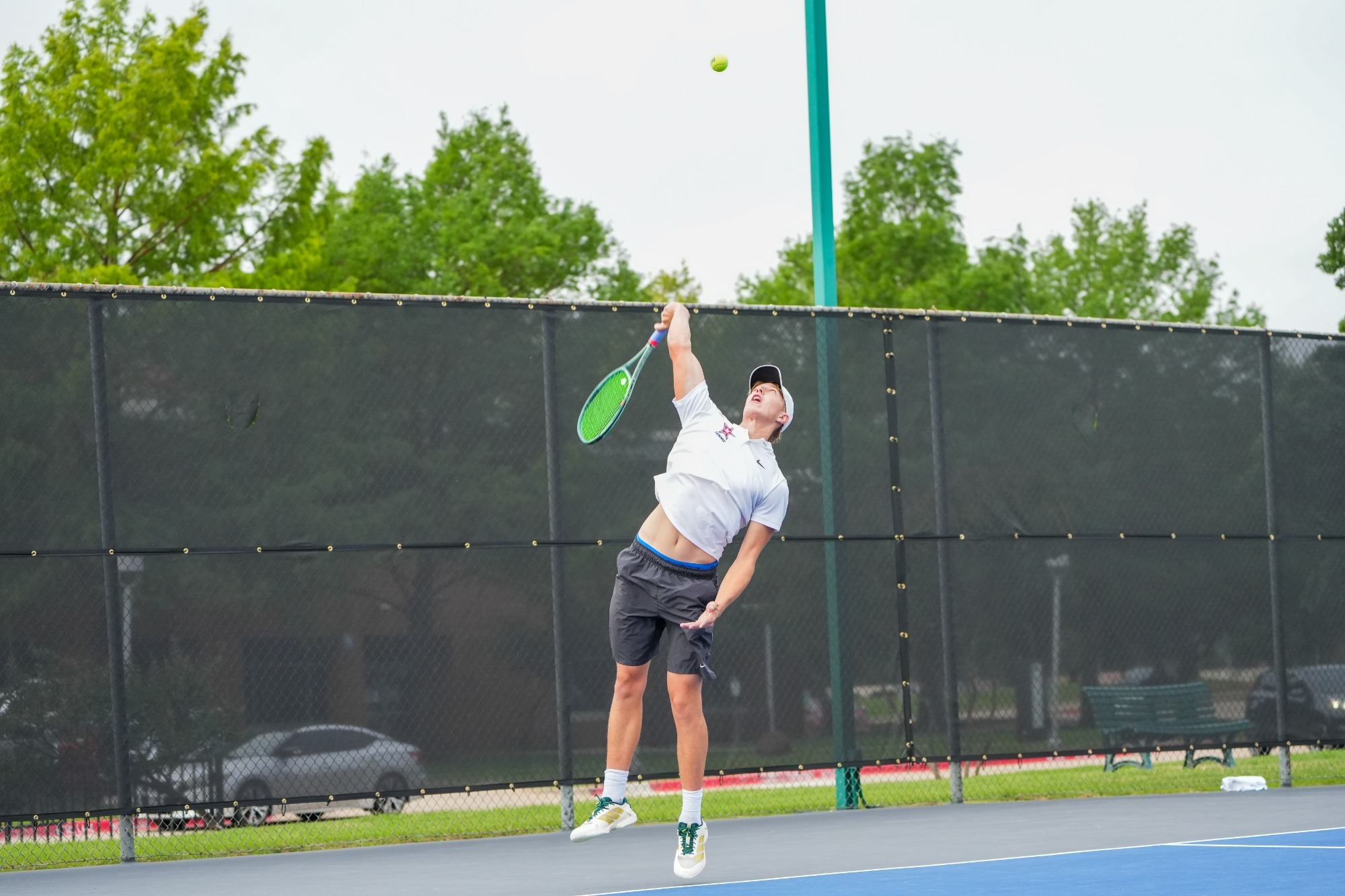 Luca Morris serves during his opening match of the NJCAA national tournament.