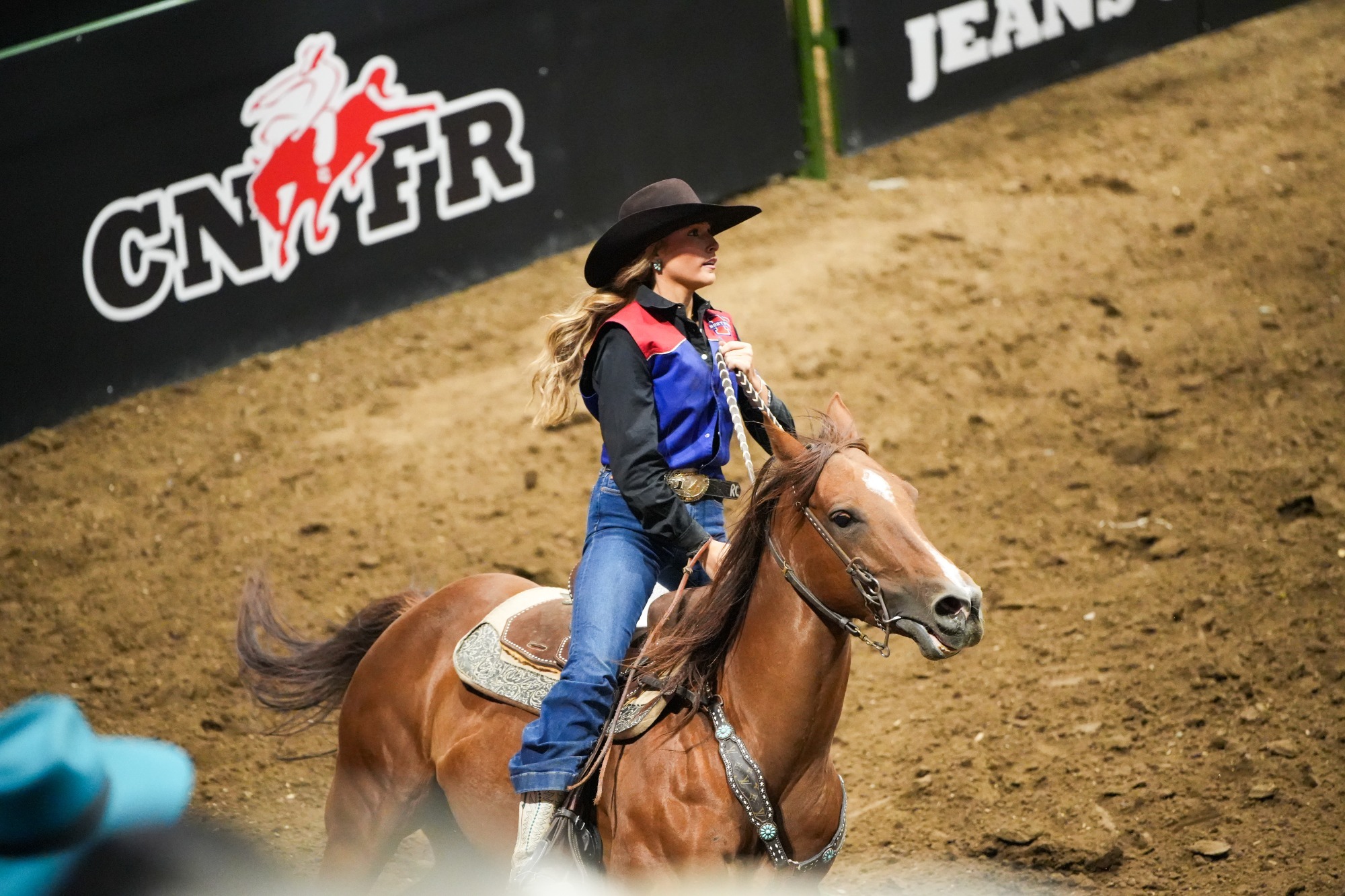 Raegan Chance glances at the replay of her ride after her Go 3 run at the CNFR.