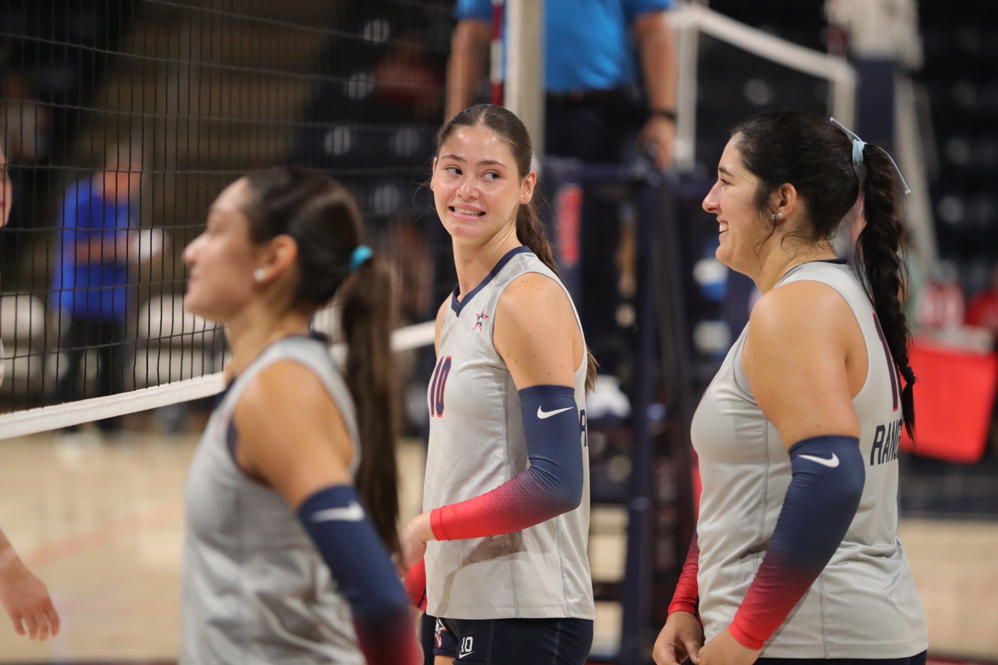 Woods and Rodriguez smiling during a volleyball match