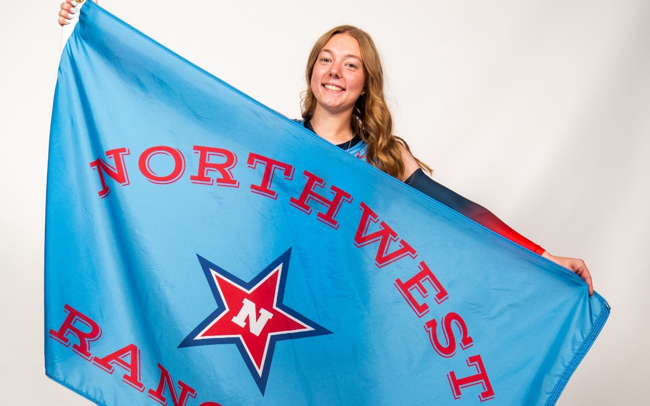 Dallas White poses with a NWCC flag
