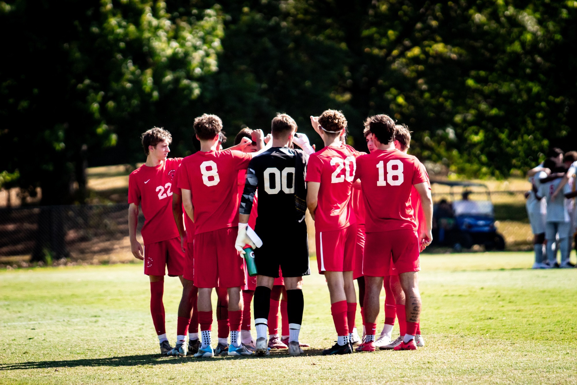 Men's Soccer in a team huddle