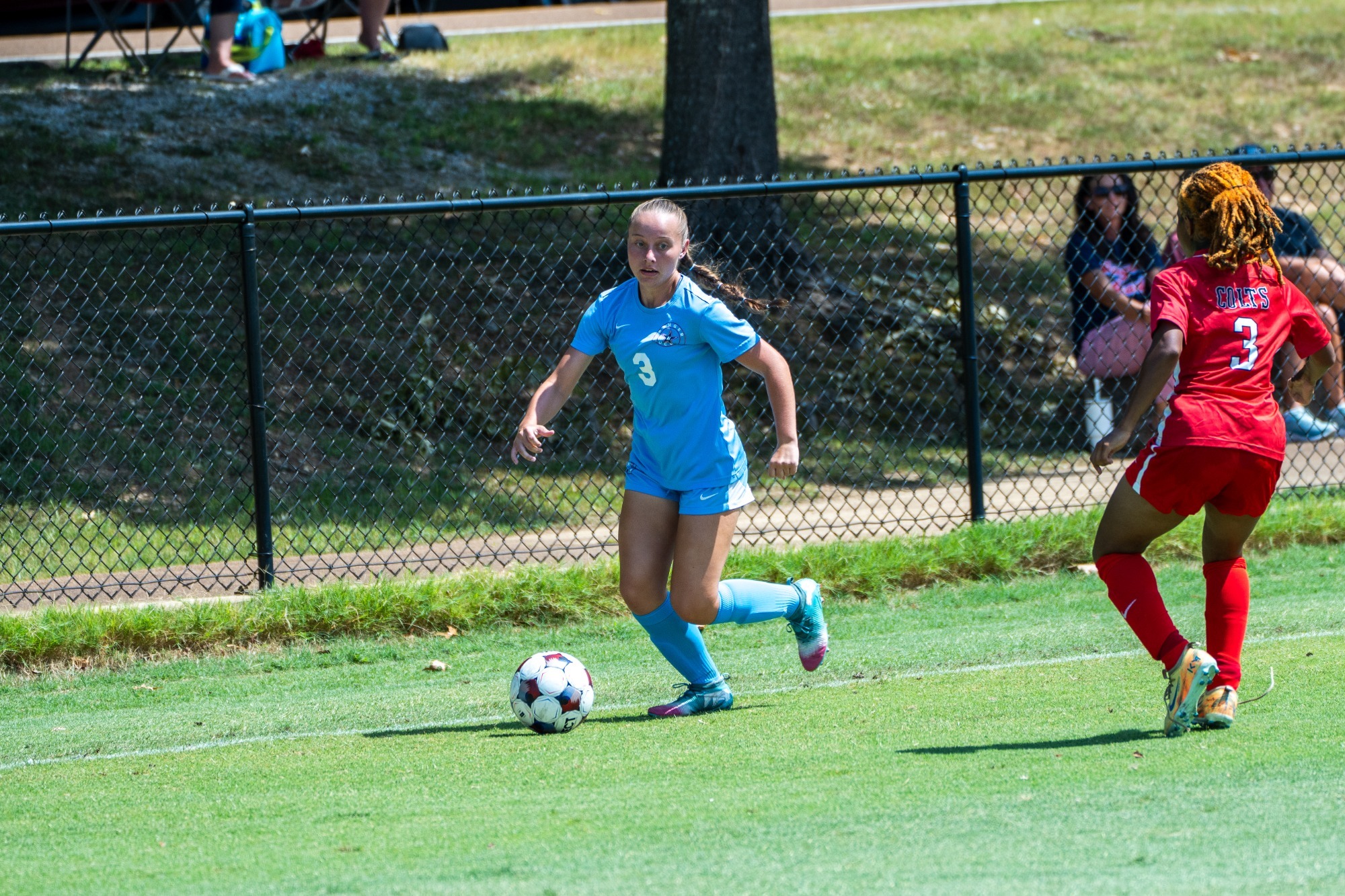 Holt dribbling past a defender