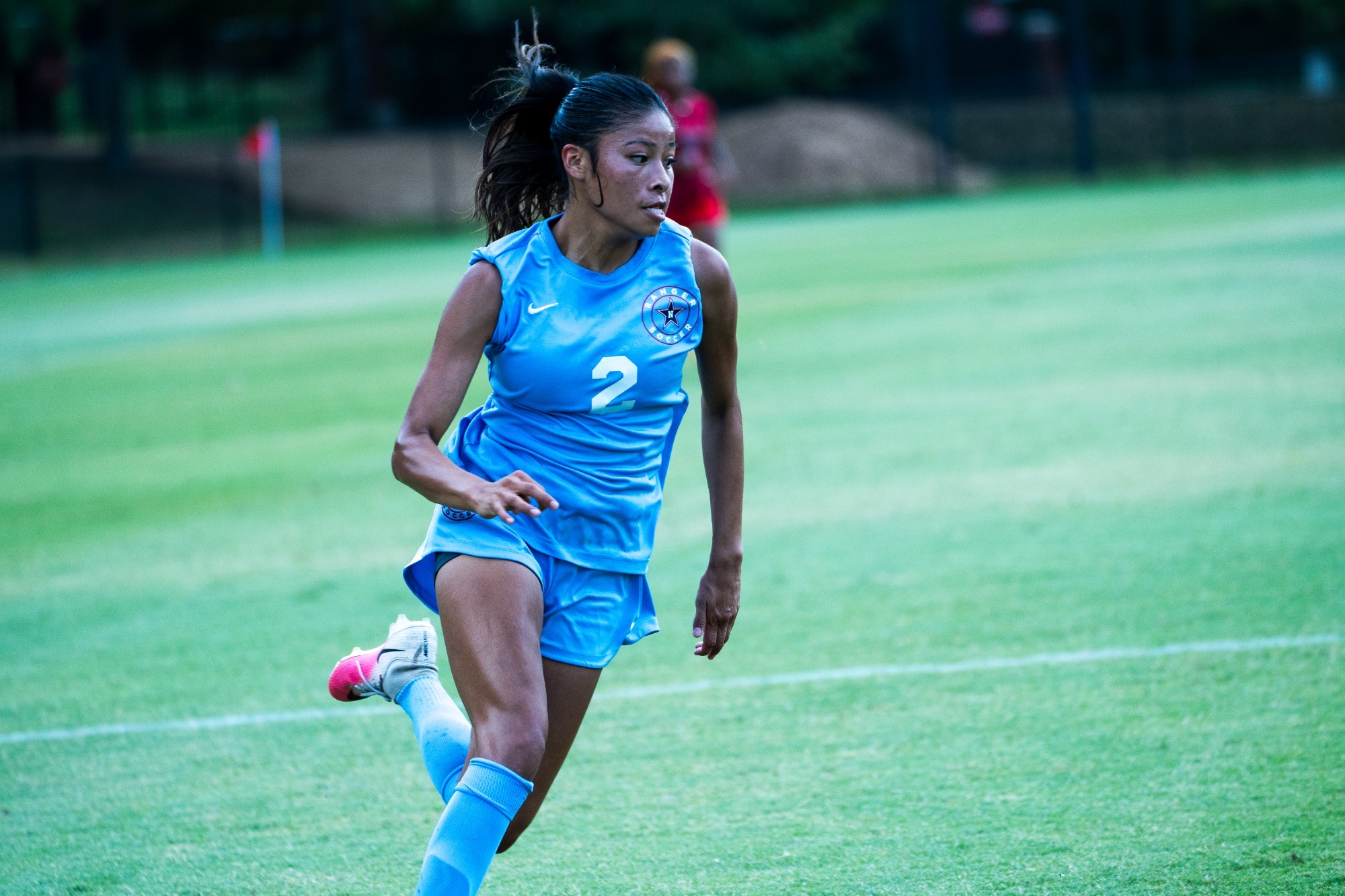 Yazzlyn Alex dribbles the ball down the field. 