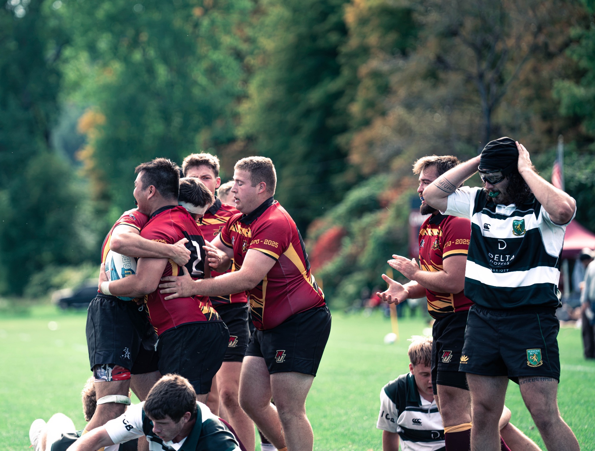 Men's Rugby celebrating a successful try. 