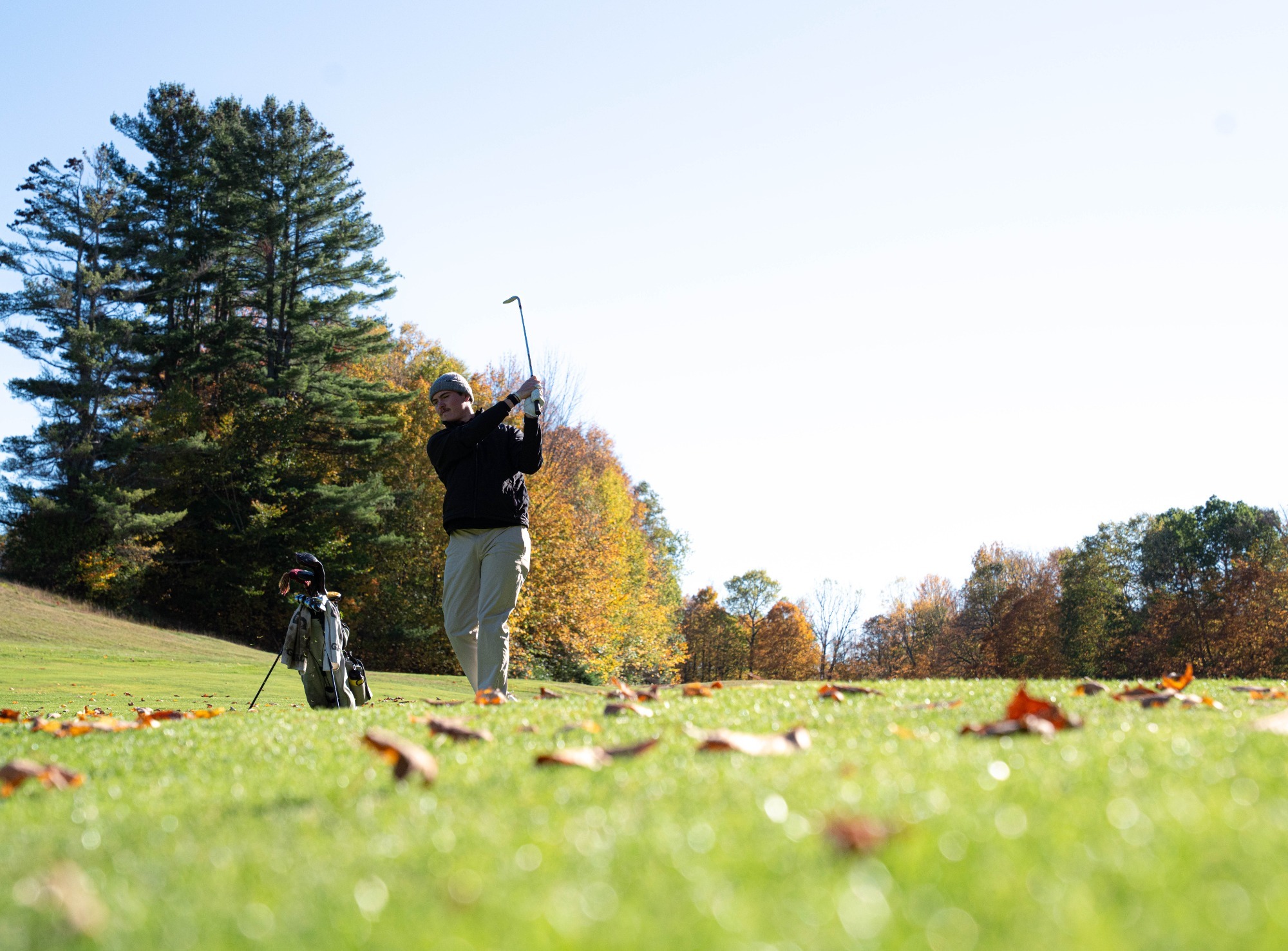 Bertrand with an iron on the fairway at the GNAC Championships. 