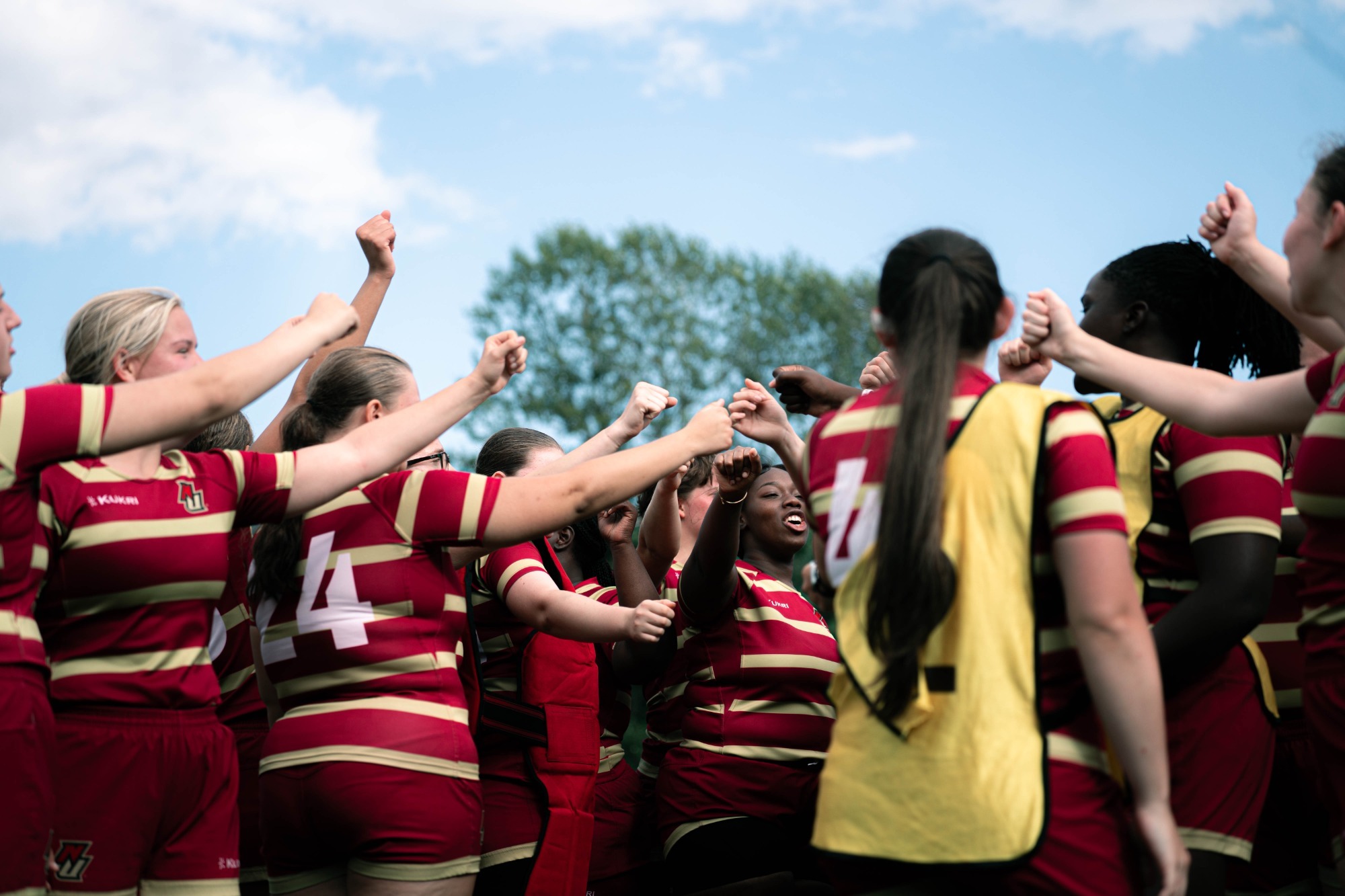 The Women's Rugby team breaking down a huddle. 