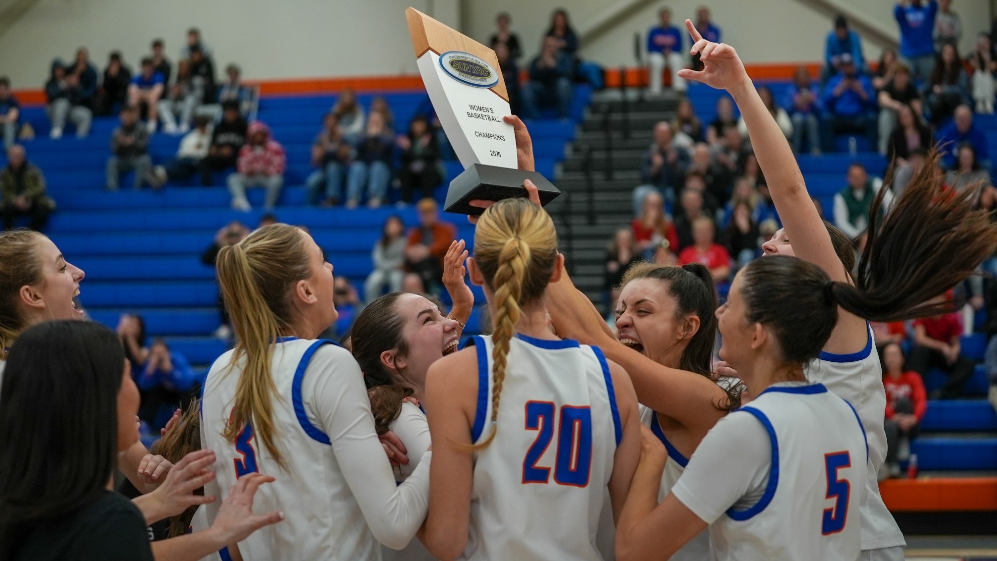Women's Basketball 2026 SUNYAC Champions celebrate with the trophy
