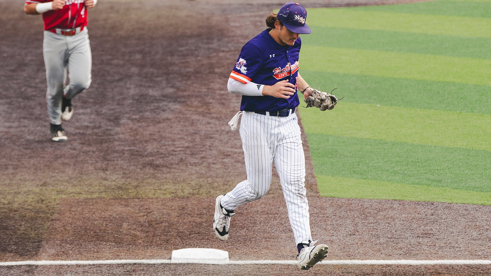 Michael McAloose runs off the field after collecting the final out of the eighth inning Saturday.