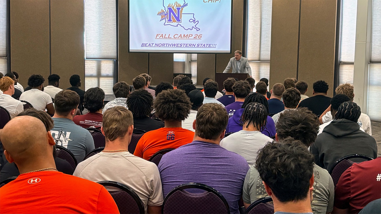 The Northwestern State football team listens to Director of Athletics Kevin Bostian speak during report day. 