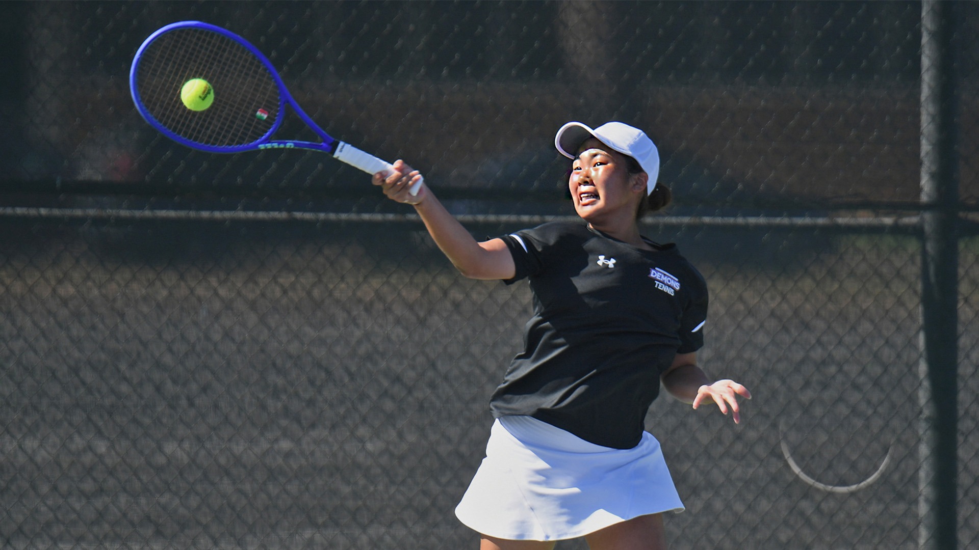 Lady Demon tennis player Nico Tagami returns a shot during the first day of the Lady Demon Invitational.