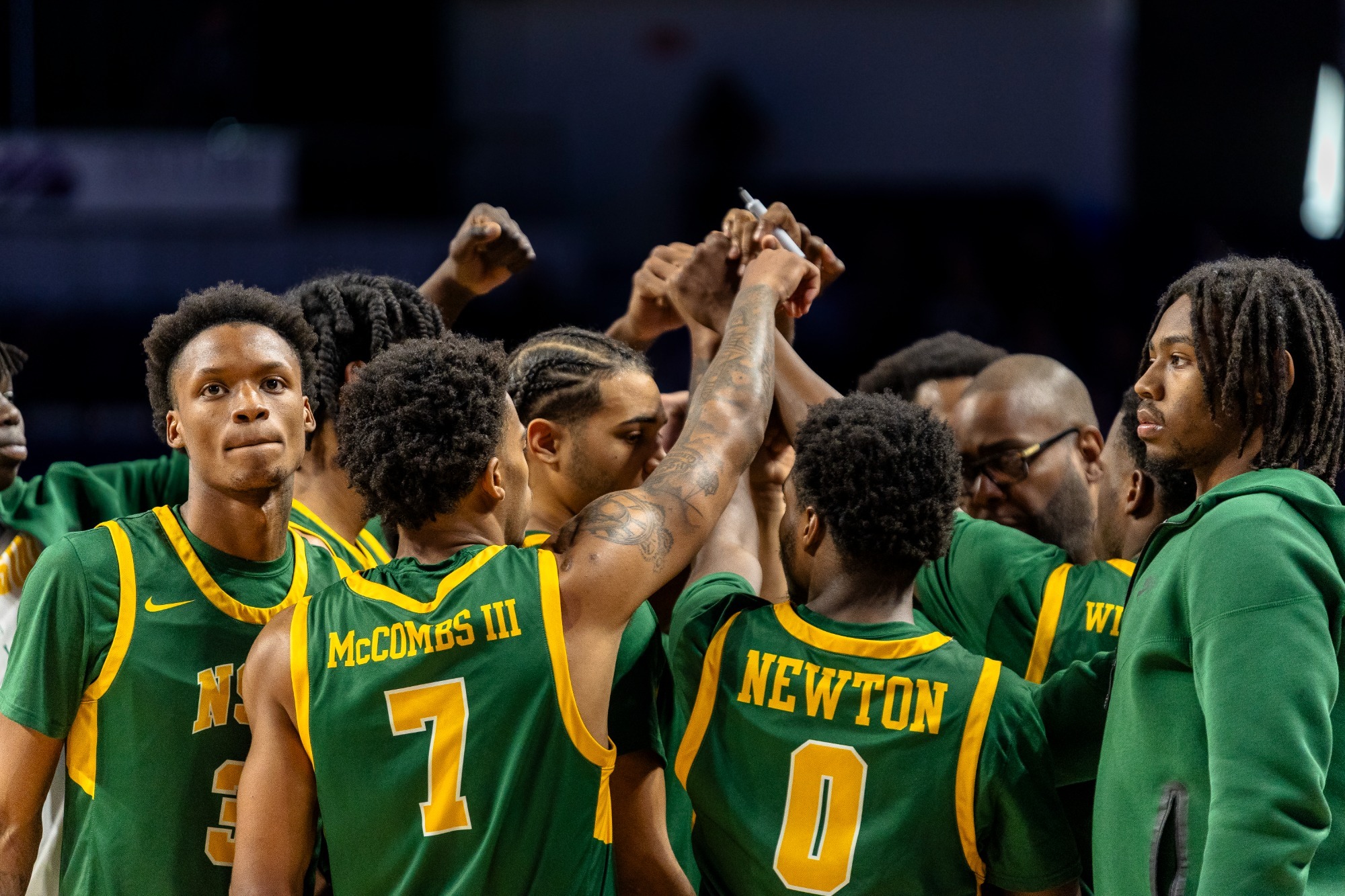 Men's basketball team huddle at James Madison