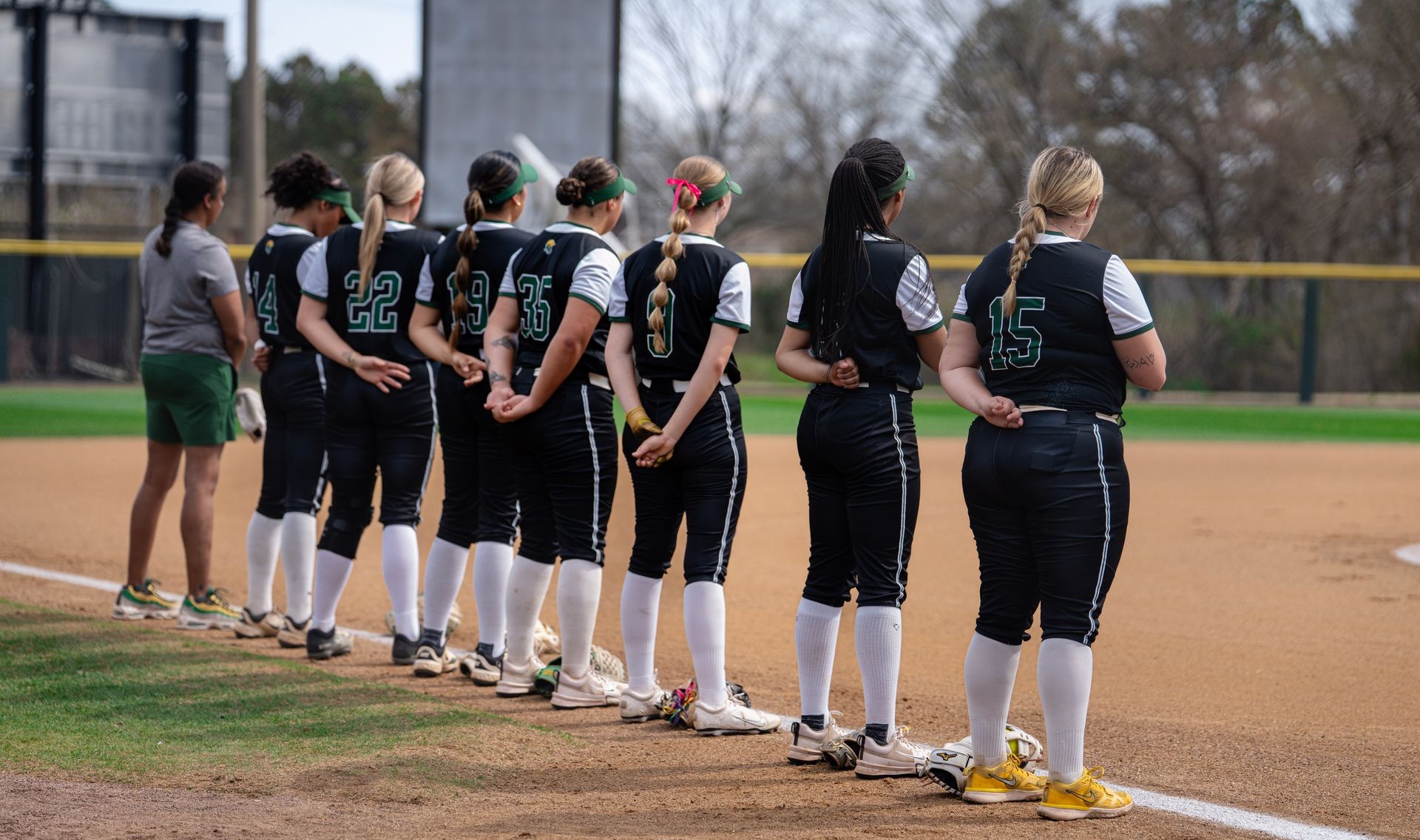 Softball Spartans line up for the anthem