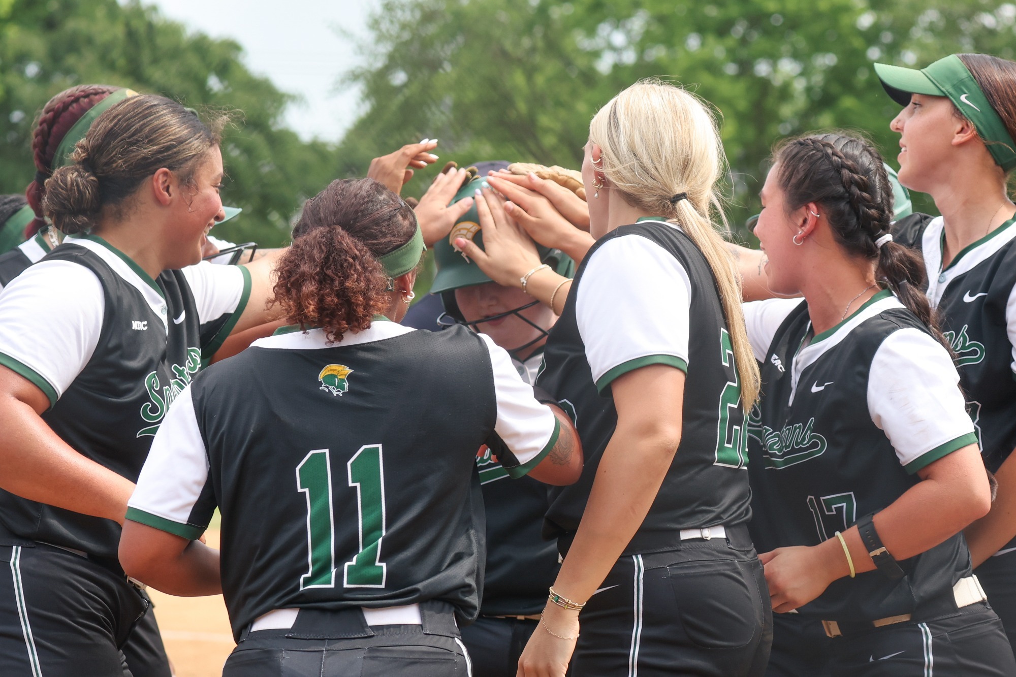 Team celebration after Maddy Morris homers on Senior Day