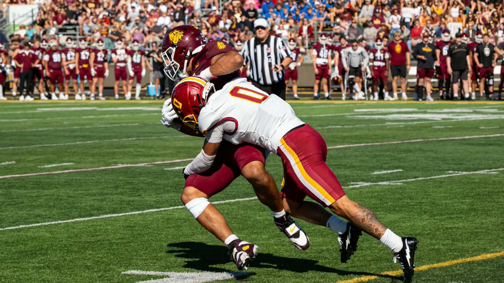 Kegan Mountain (0) tackles a Minnesota Duluth offensive player