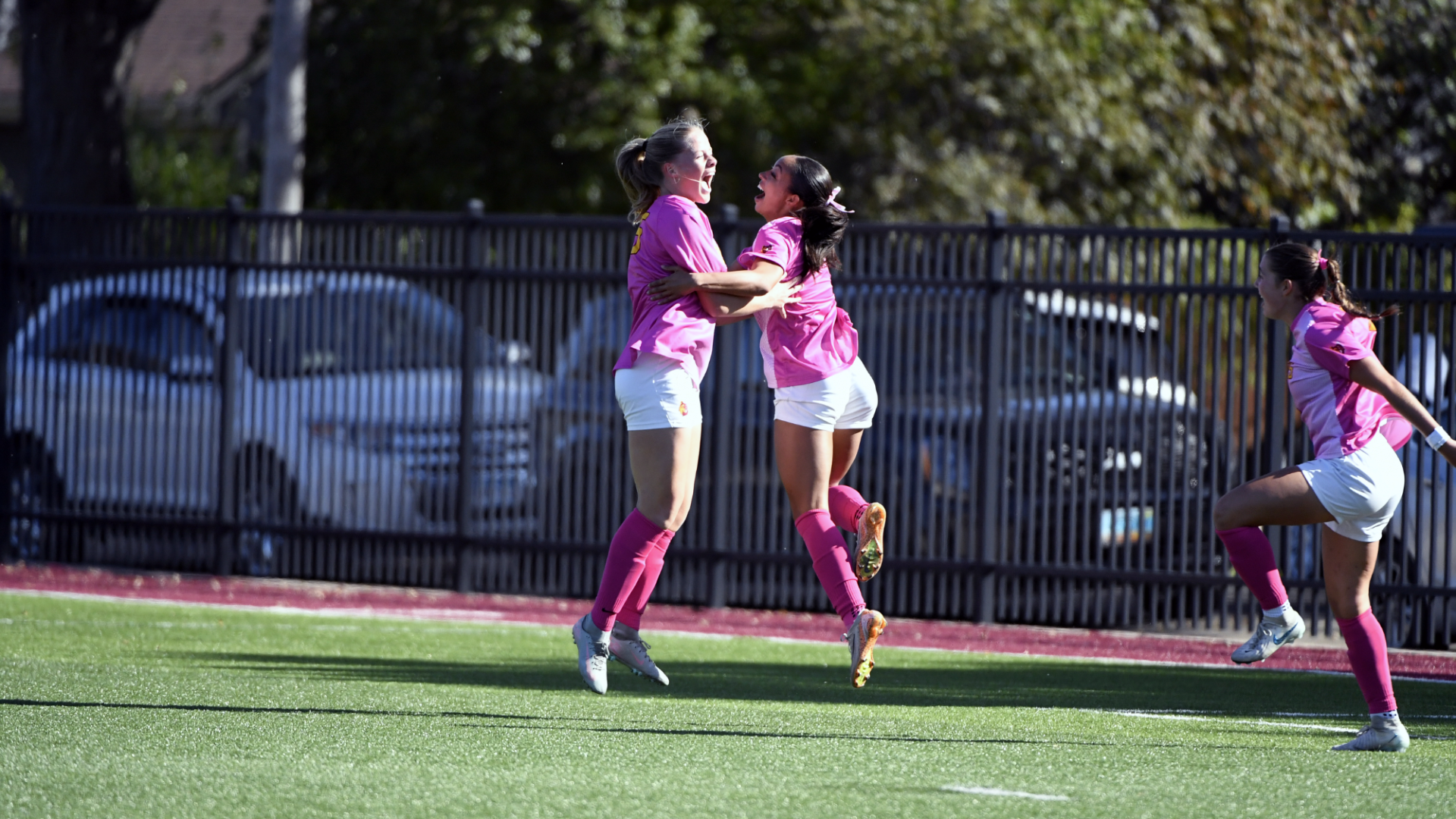 Chloe Wallhead and Deshani Peters celebrate after Wallhead scored the game tying goal against Wayne State College
