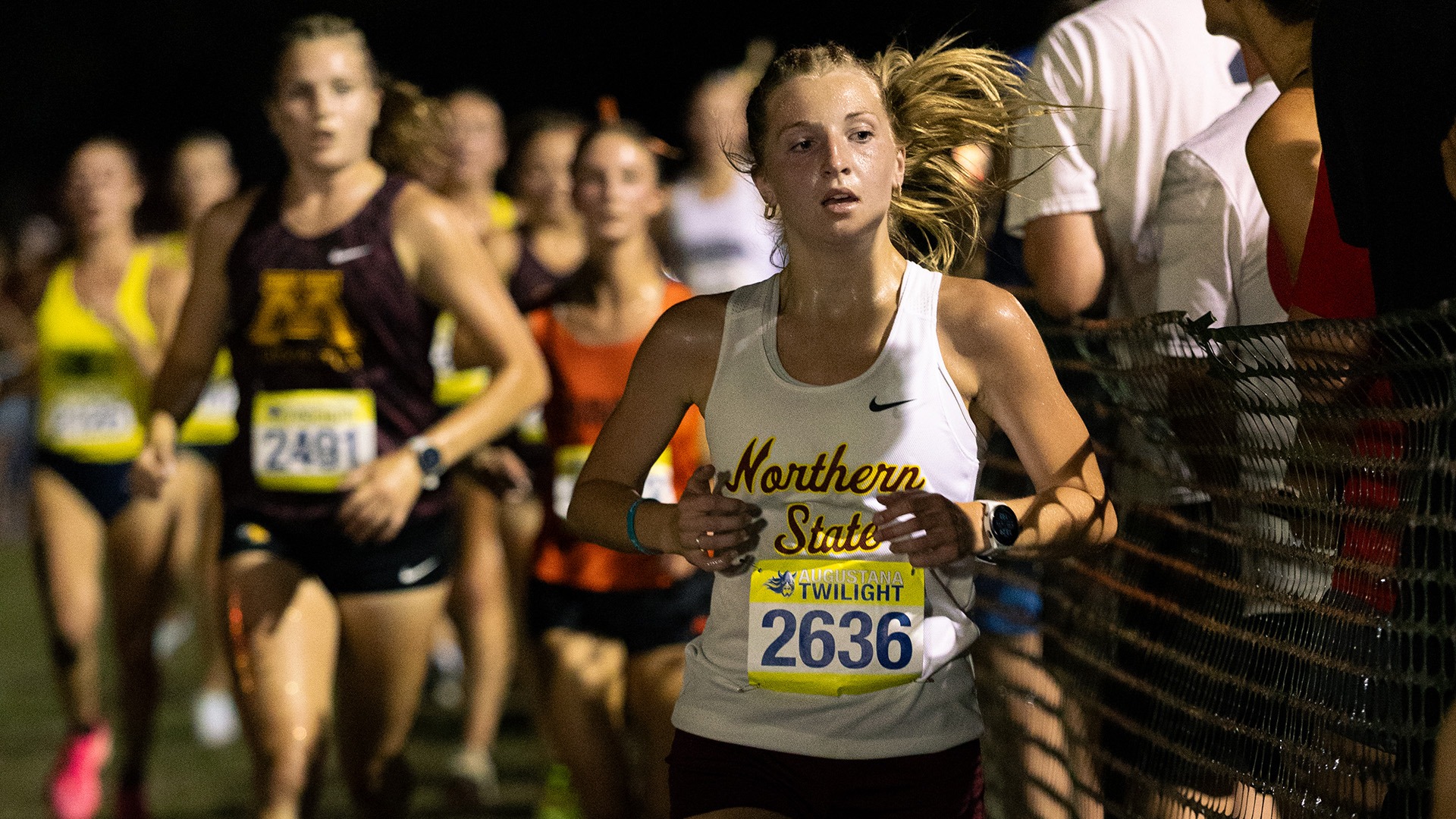 Abby Hasart running the Augustana Twilight race in 2026