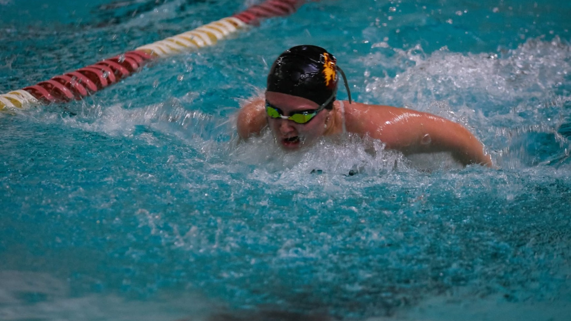NSU swimmer getting breathes during a race at the Barnett Center.
